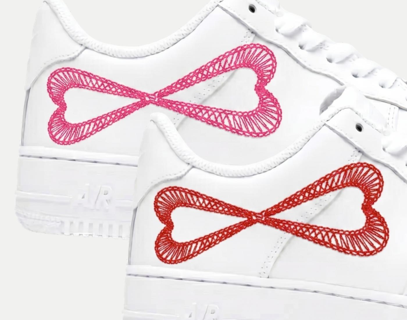 Close-up of two mirrored hearts crossing at the center to form an infinity symbol on two Air Force 1 sneakers